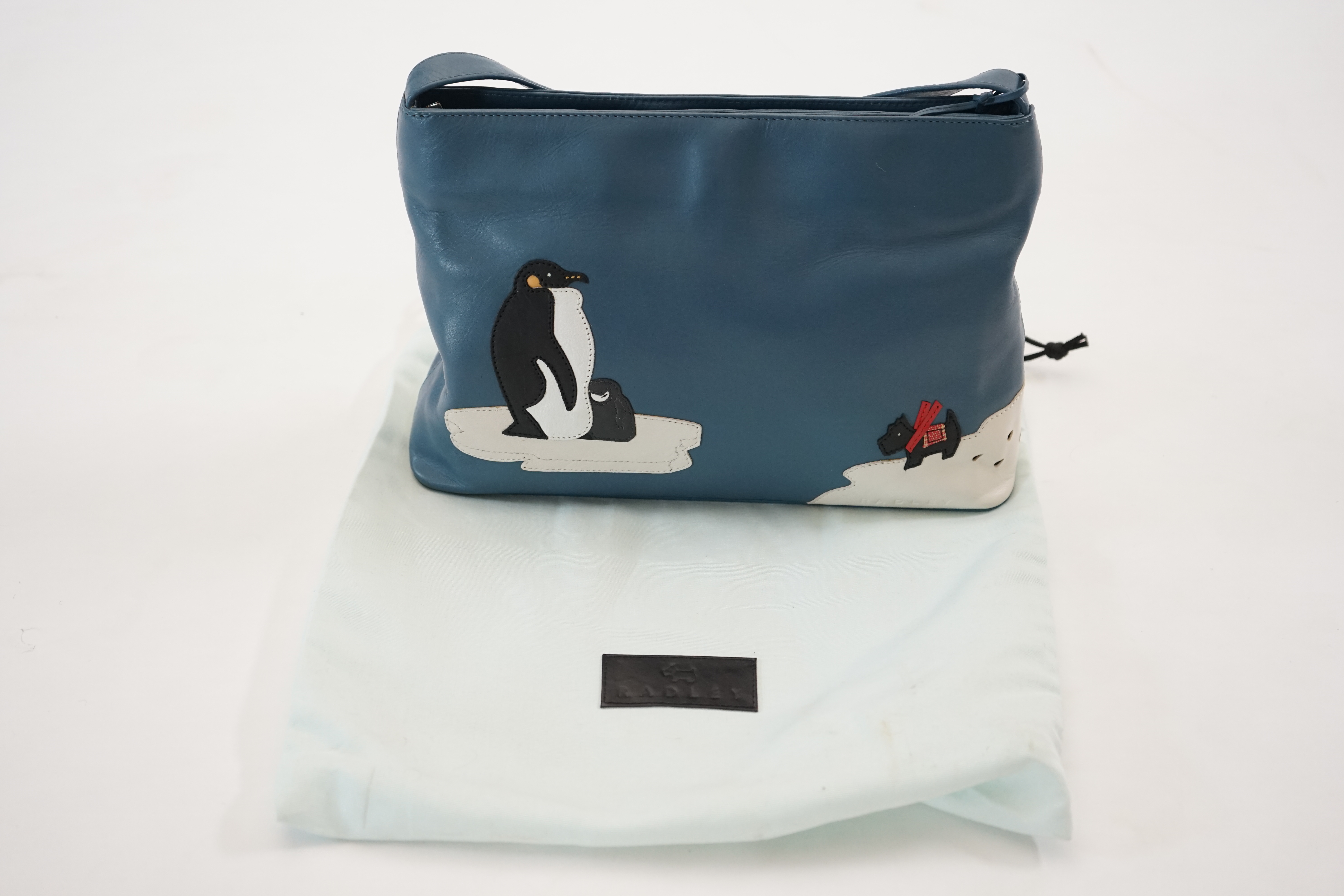 A blue Radley 'Penguins' grab bag 2002, width 29.5cm, depth 8cm, height 19.5cm